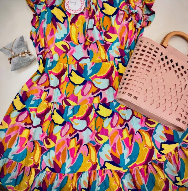 Bright floral dress and pink tote with bracelet and necklace